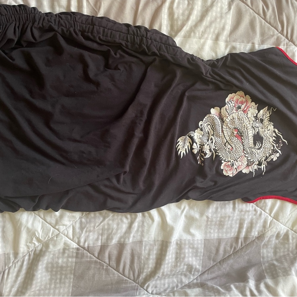 Black dress with design on front.